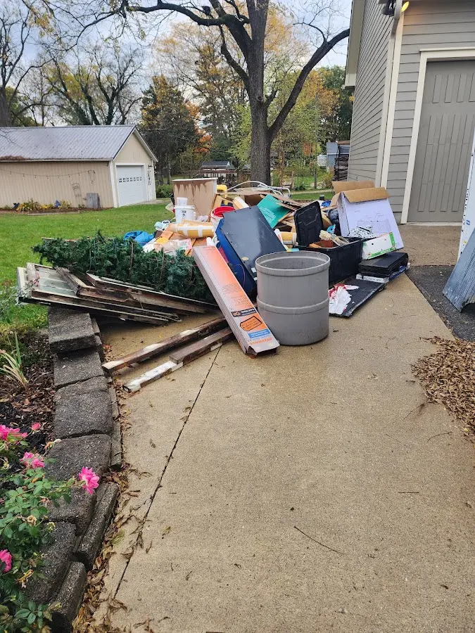 Dumpster being loaded with debris for Commercial Dumpster Rental in Des Moines